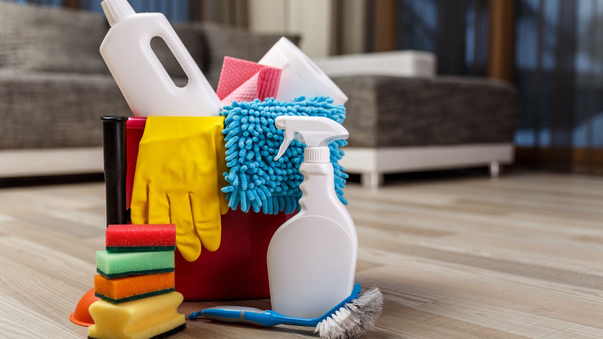 A pile of cleaning supplies sitting on top of a wooden floor